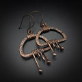 Copper fringe earrings flat lay, grey background, angled view — Nimbus Storm