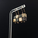 Terra Mosaic earrings — lava rock and jasper cube grid, dark background