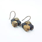 Lava stone and jasper earrings — overhead flat lay, white background