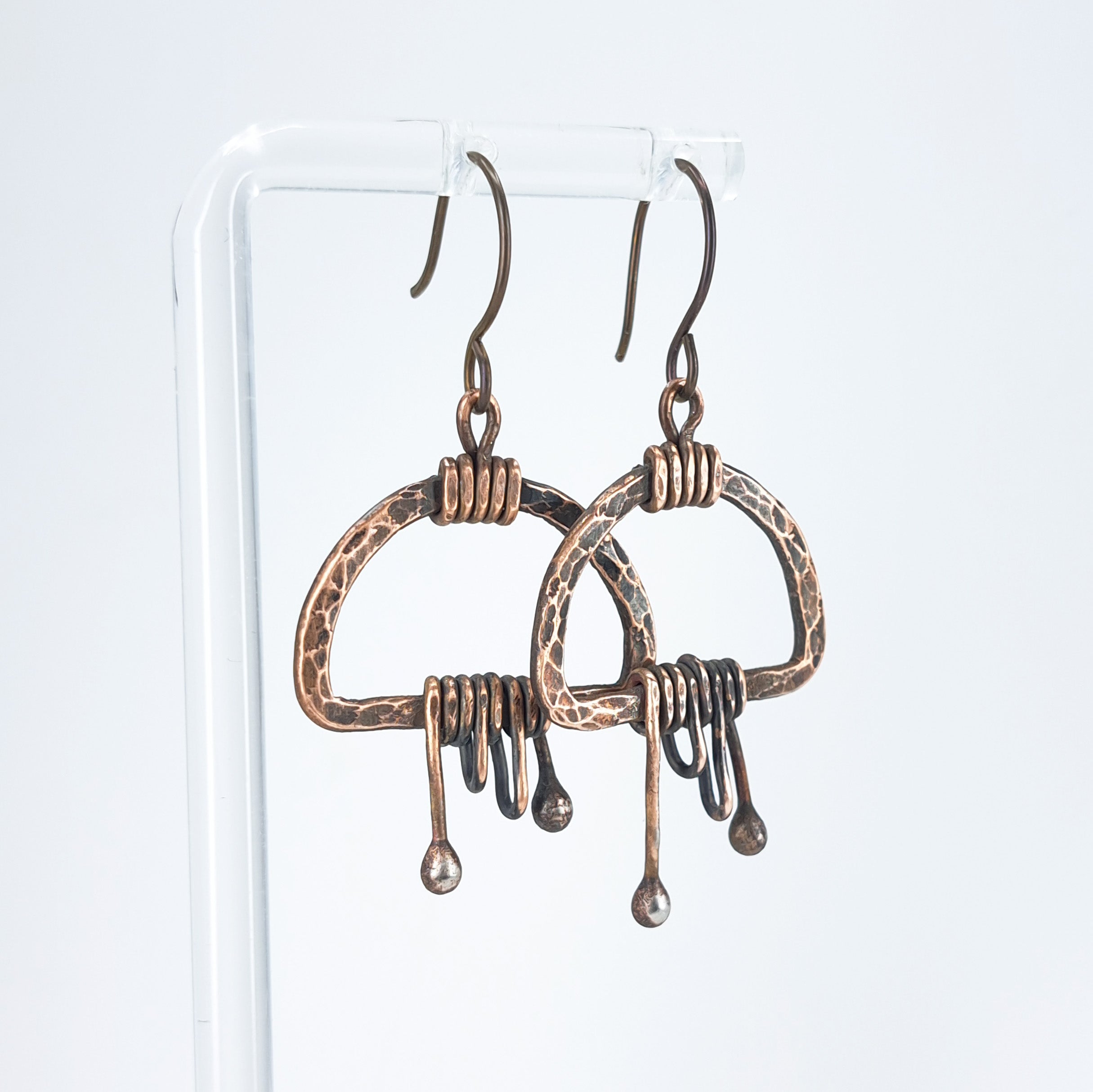 Earrings on acrylic stand, white background, front view — Nimbus Storm