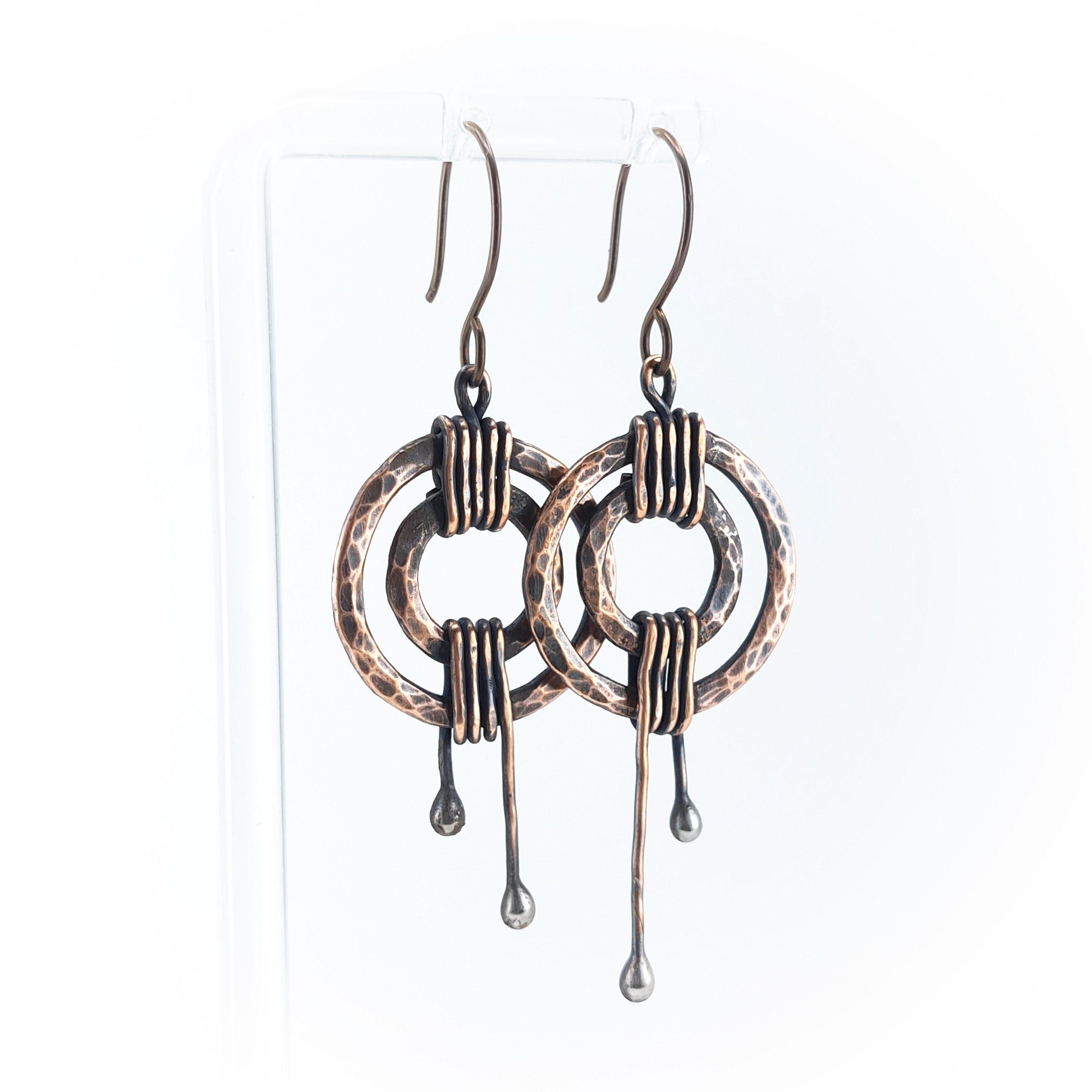 Hammered copper double ring earrings on white background — coiled wire wrap, ball drop stems, RVSTICA