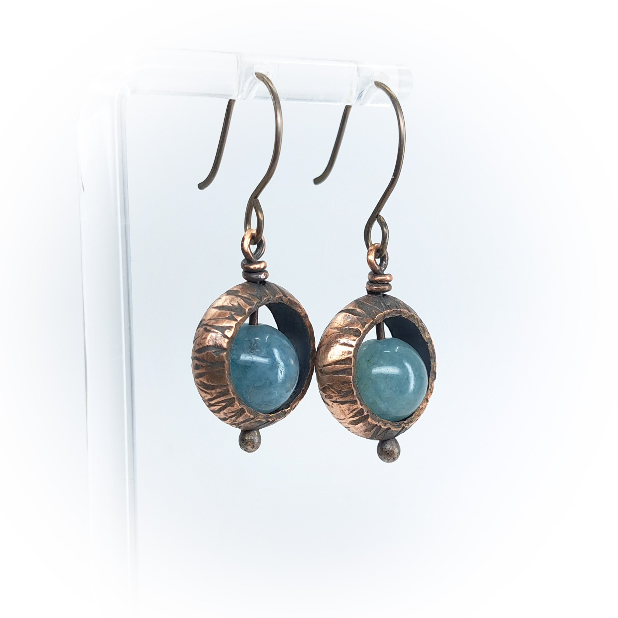 Copper ring earrings with aquamarine chalcedony on acrylic stand, white background — full view, ball drop detail