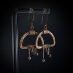 Earrings on acrylic stand, dark background, front view — Nimbus Storm