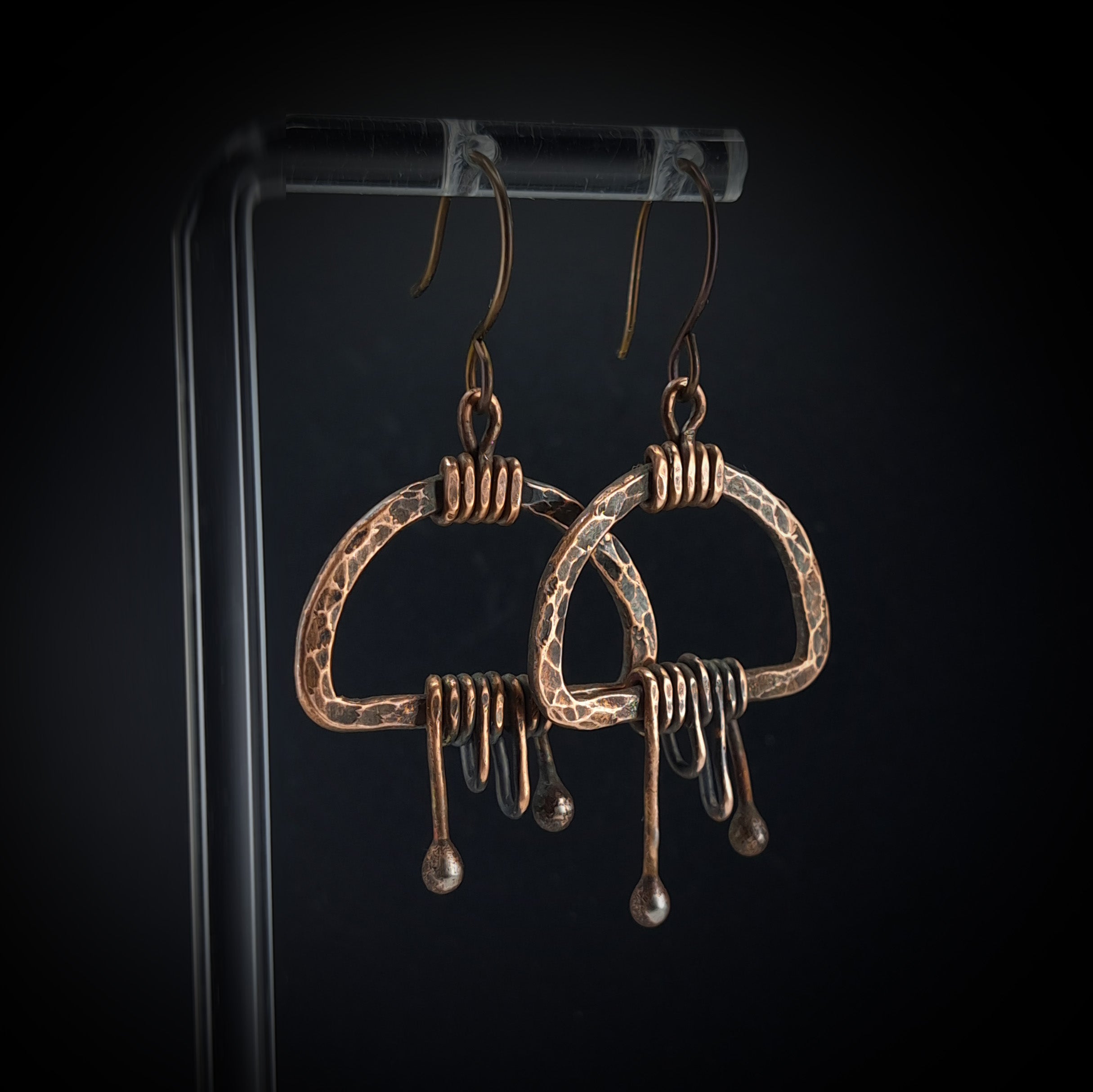 Earrings on acrylic stand, dark background, front view — Nimbus Storm