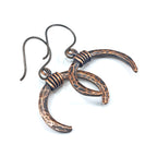 Lunar Horns earrings — flat lay on white background