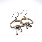 Earrings flat lay, white background, overhead view — Nimbus Storm