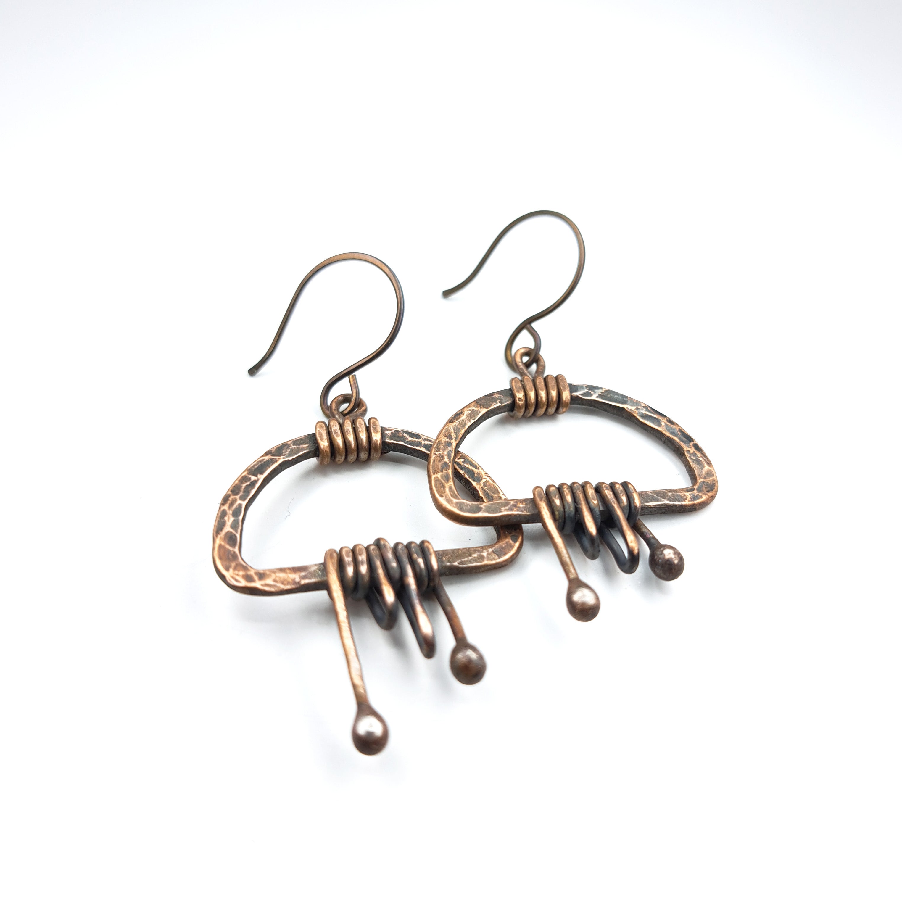 Earrings flat lay, white background, overhead view — Nimbus Storm