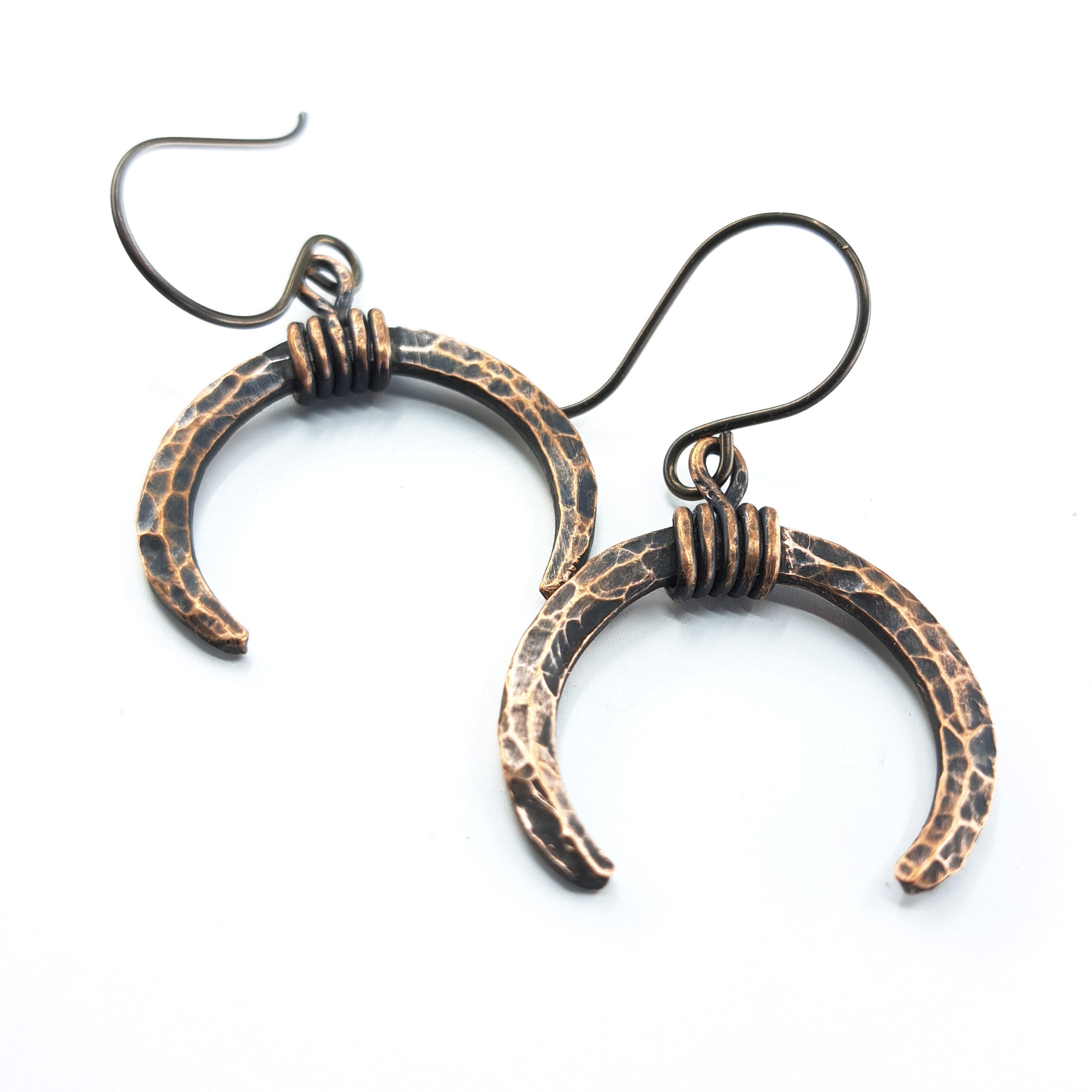 Lunar Horns earrings — close-up showing hammered texture and wire wrap