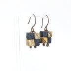 Terra Mosaic earrings on white acrylic stand — side view, white background