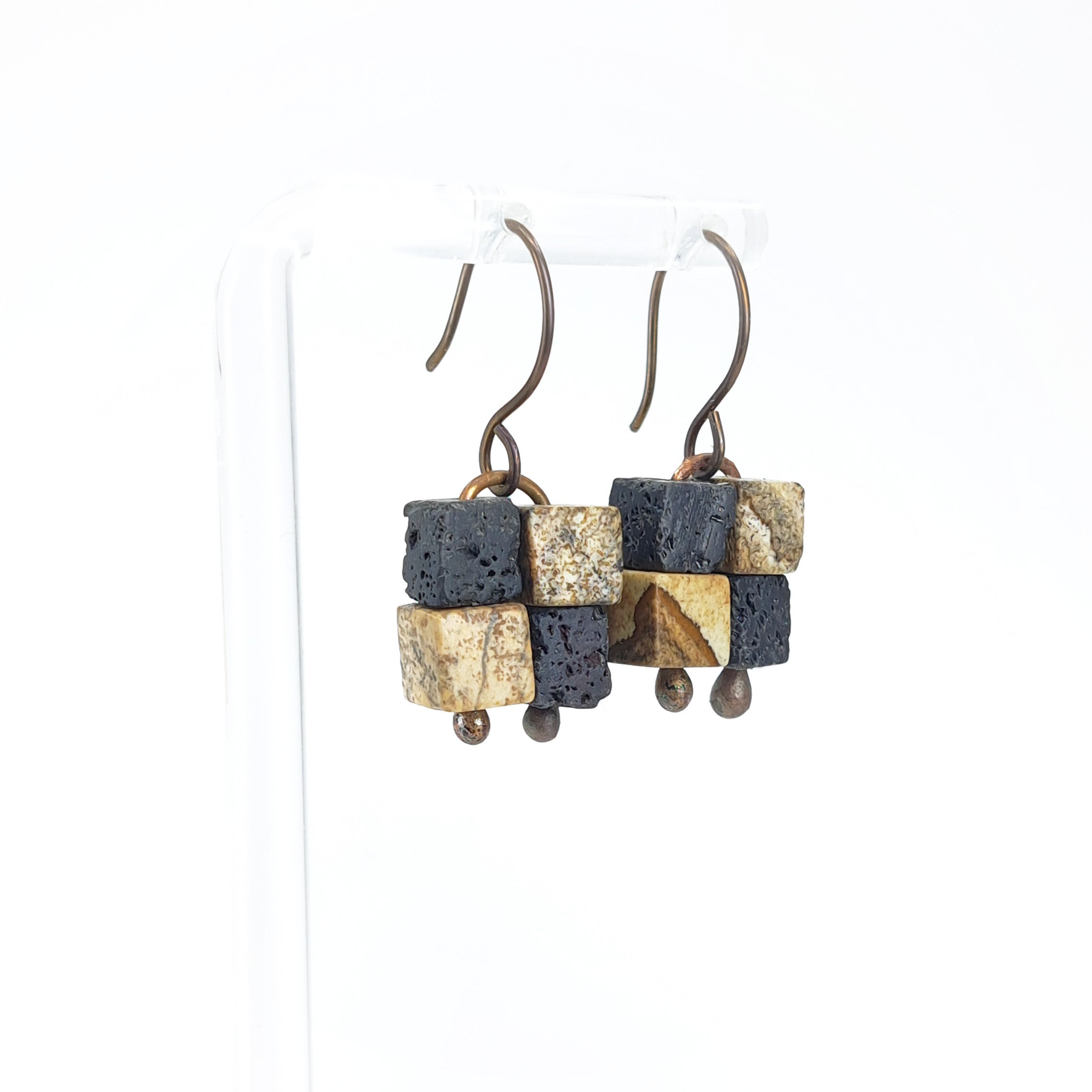 Terra Mosaic earrings on white acrylic stand — side view, white background