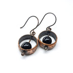 Copper & black onyx earrings flat lay, white background, top-down view showing depth — Meridian