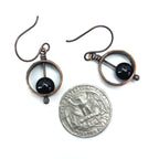 Copper & black onyx earrings with quarter for size reference, approximately 5/8" wide — Meridian