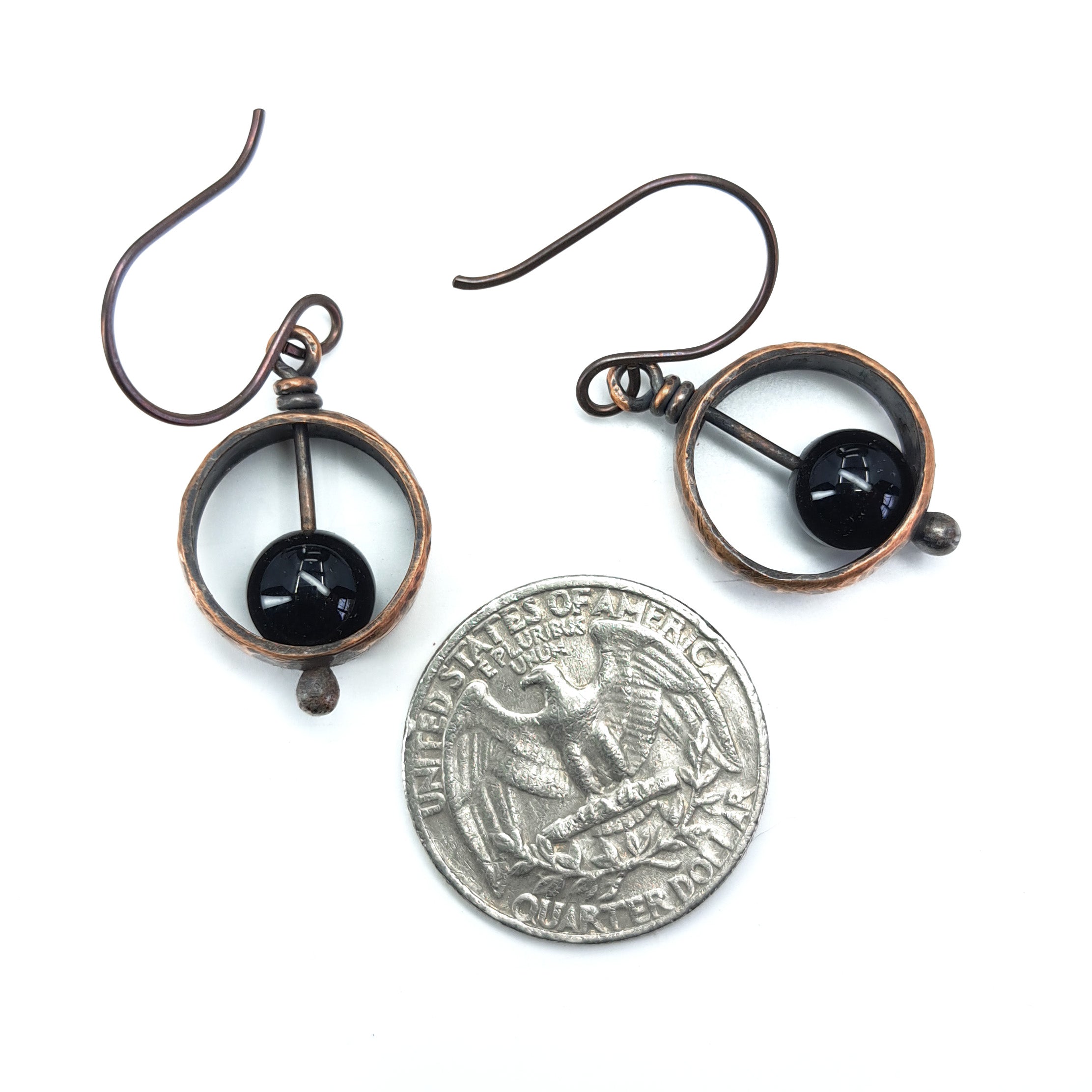Copper & black onyx earrings with quarter for size reference, approximately 5/8" wide — Meridian