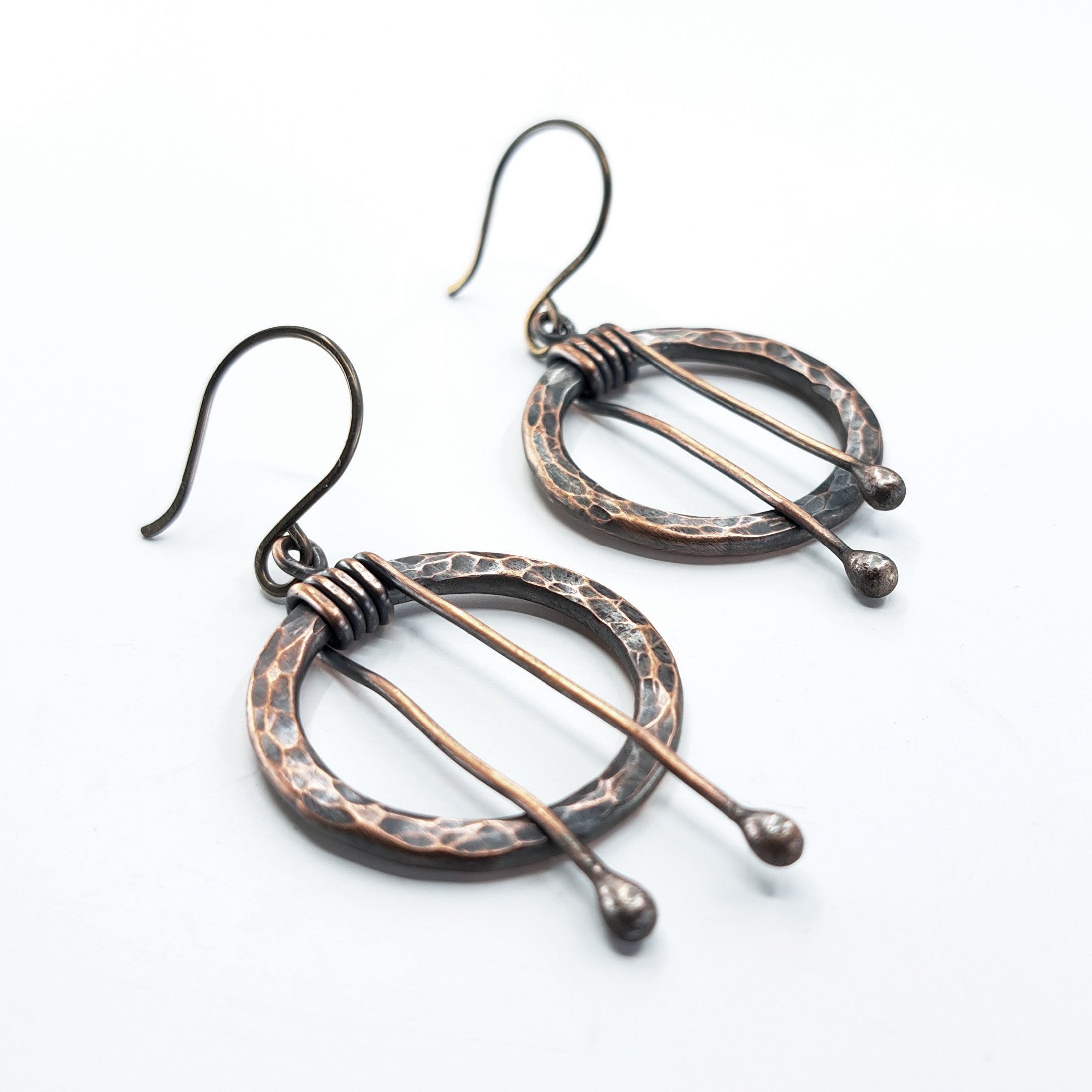 Hammered copper hoop earrings flat lay, white background — 1 inch diameter, 2 inch total length