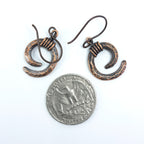 Copper spiral earrings with quarter for size reference, approximately 5/8" wide — Vortex