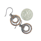 Copper double hoop earrings with quarter for scale