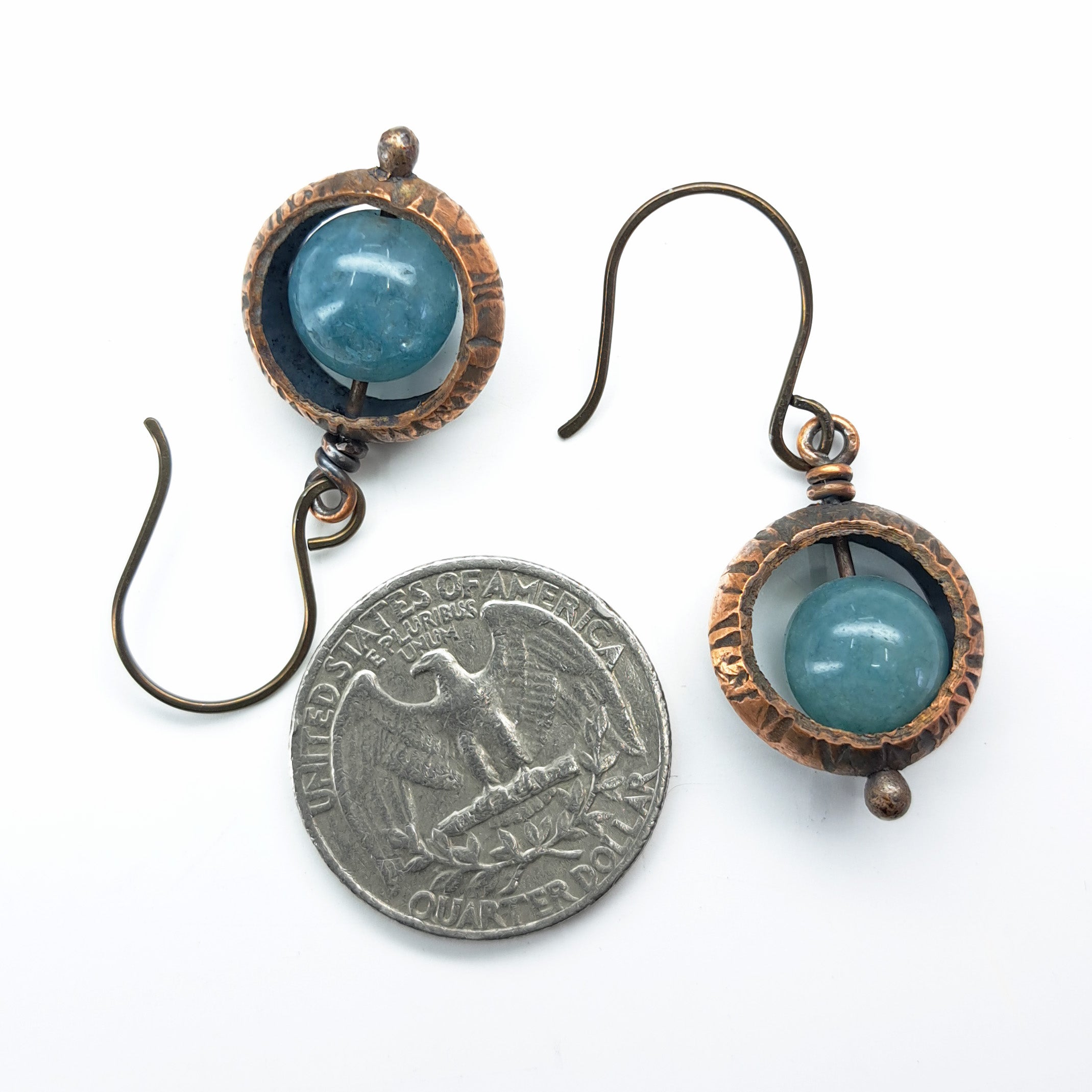 Copper ring earrings with aquamarine chalcedony with quarter coin for size reference — ¾ inch diameter, white background