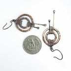 Hammered copper double ring earrings with quarter coin for size reference — ~1 inch diameter, white background